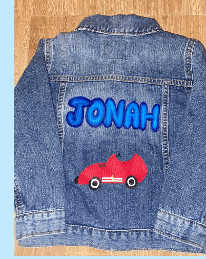 Denim jacket hand-painted with the name JONAH and a race car